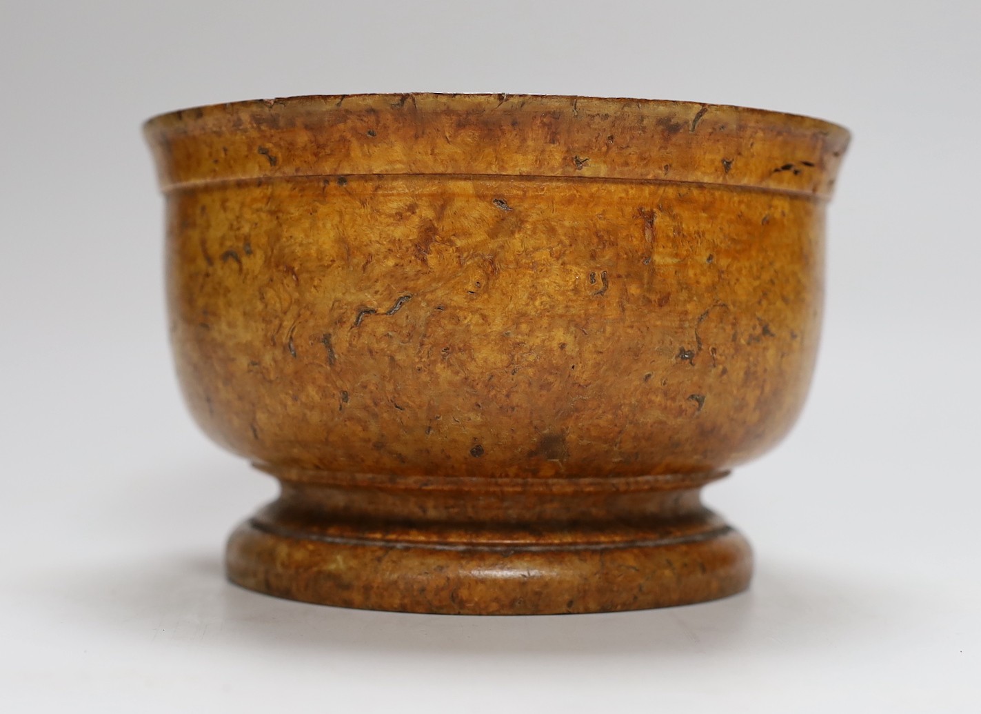 A turned burr maple bowl on pedestal base, 17cms diameter